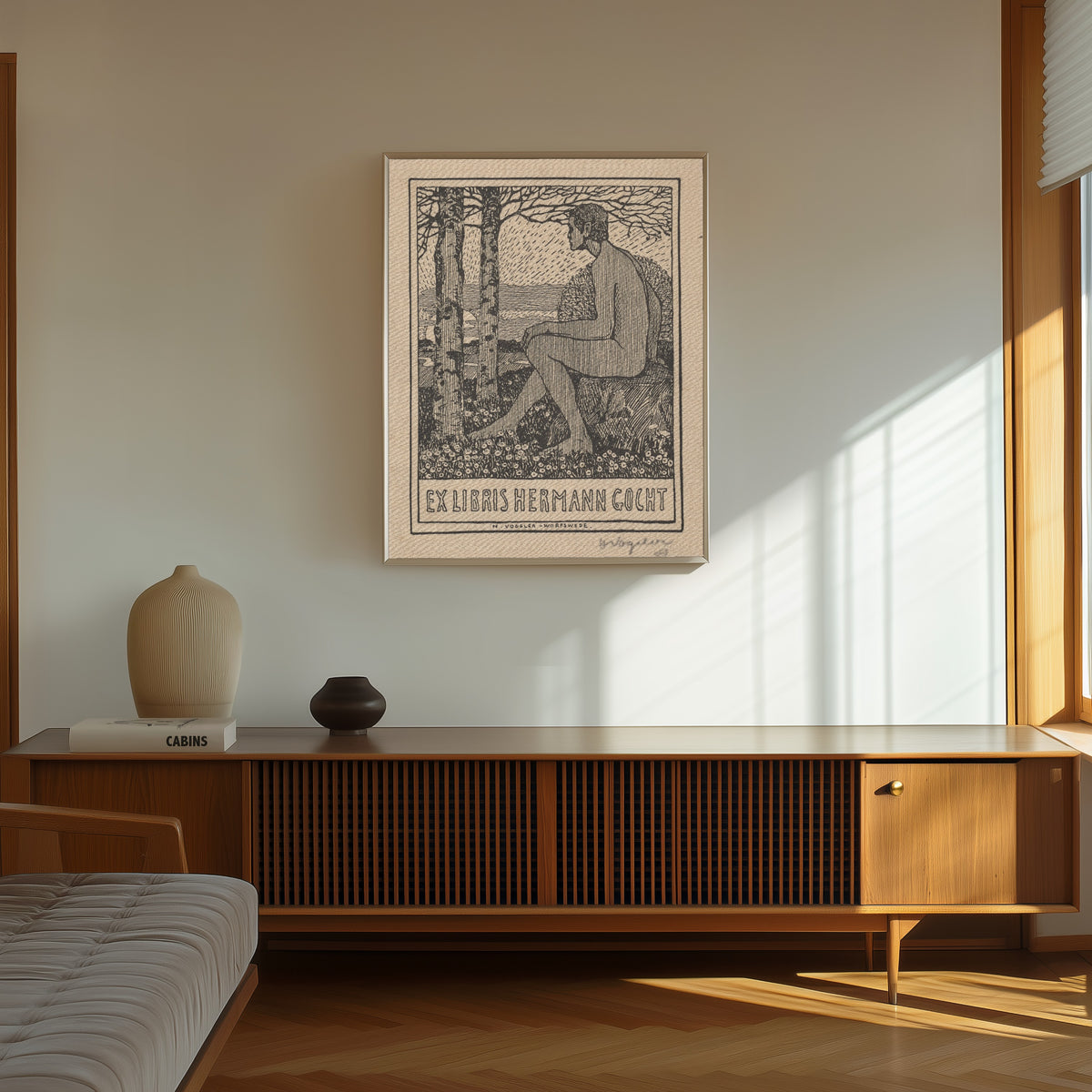 Framed art print of Ex Libris Hermann Gocht by Heinrich Vogeler, in a thin light frame on a sunlit wall above a wooden sideboard