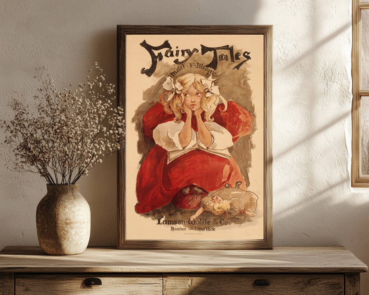 Framed art print of Fairy Tales by Mabel F. Blodgett by Ethel Reed, in a dark wood frame leaning on a rustic console beside dried flowers