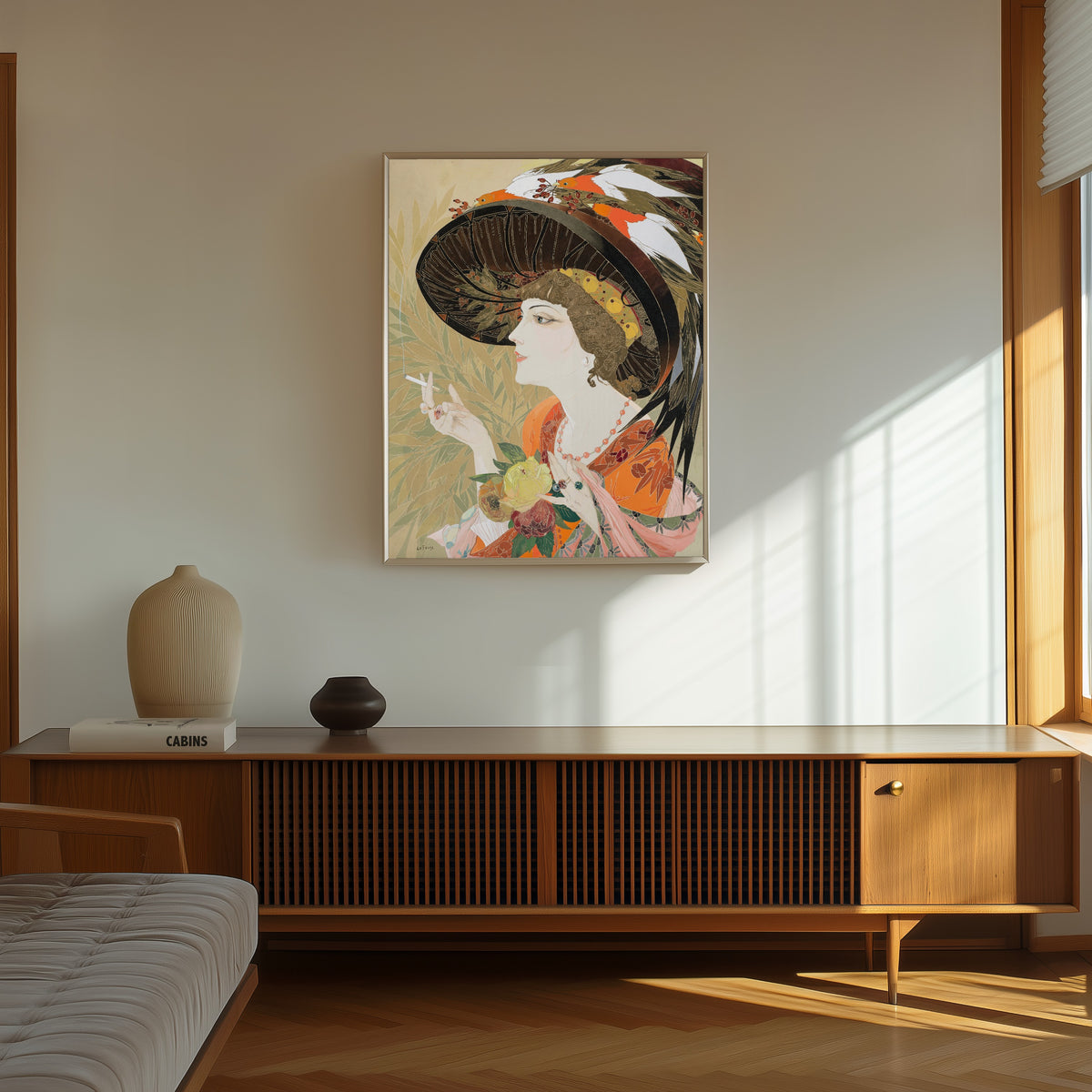 Framed art print of Femme en buste fumant de profil by Georges de Feure, in a thin light frame on a sunlit wall above a wooden sideboard