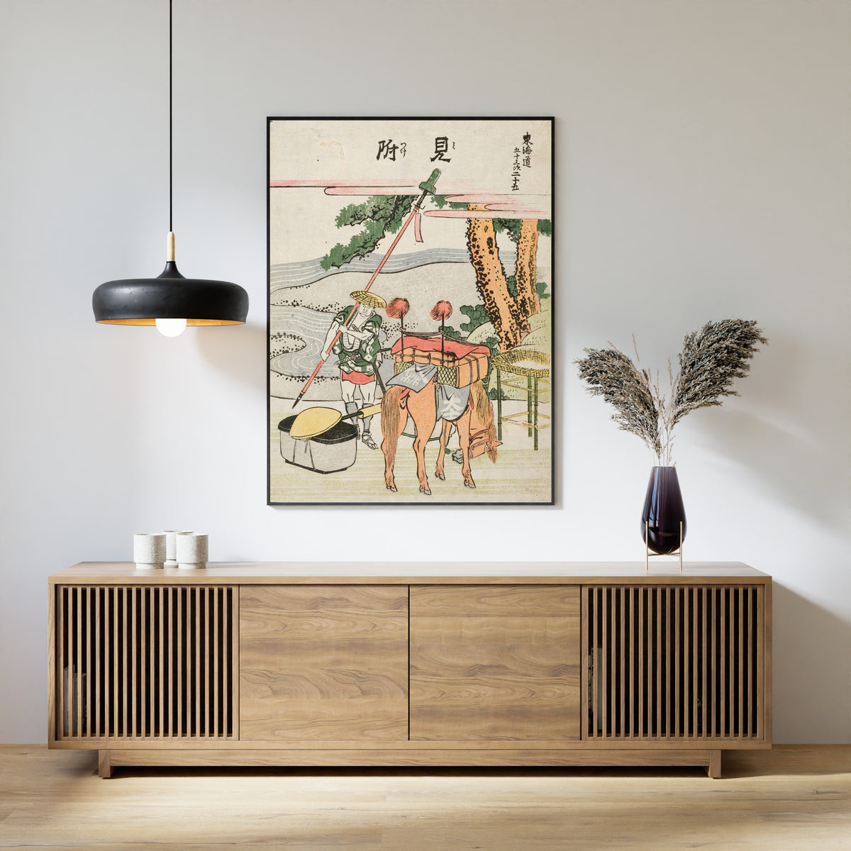 Framed art print of Fifty-three Stations of the Tōkaidō: Mitsuke by Katsushika Hokusai, above a slatted wood sideboard