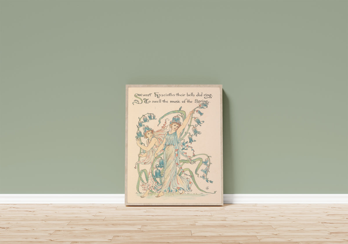Framed art print of Flora's Feast: Hyacinths by Walter Crane, in a light wood frame leaning on a sage green wall above a wooden floor