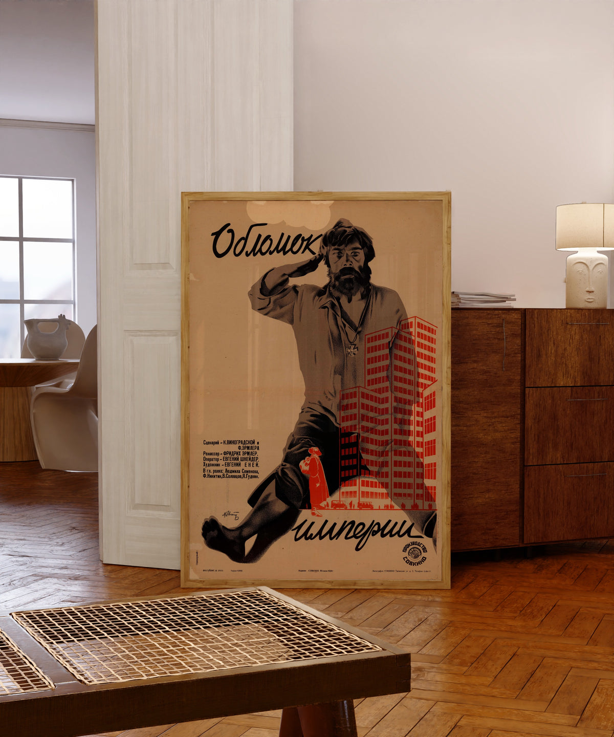 Framed art print of Fragment of an Empire by Mikhail Evstafiev, in a light wood frame leaning in a warm room with a parquet floor