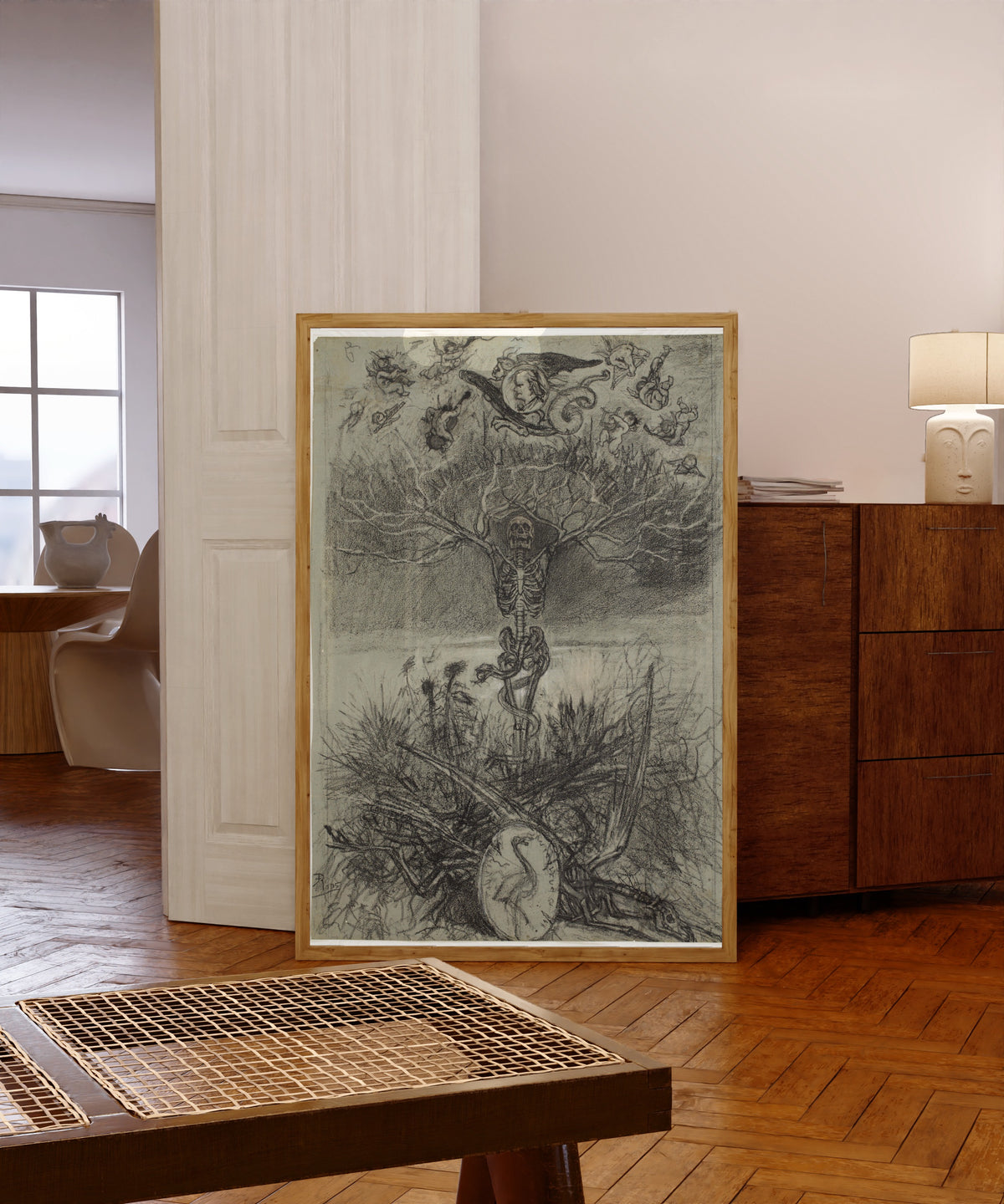 Framed art print of Frontispice des Épaves de Charles Baudelaire (final… by Félicien Rops, in a light wood frame leaning in a warm room with a parquet floor