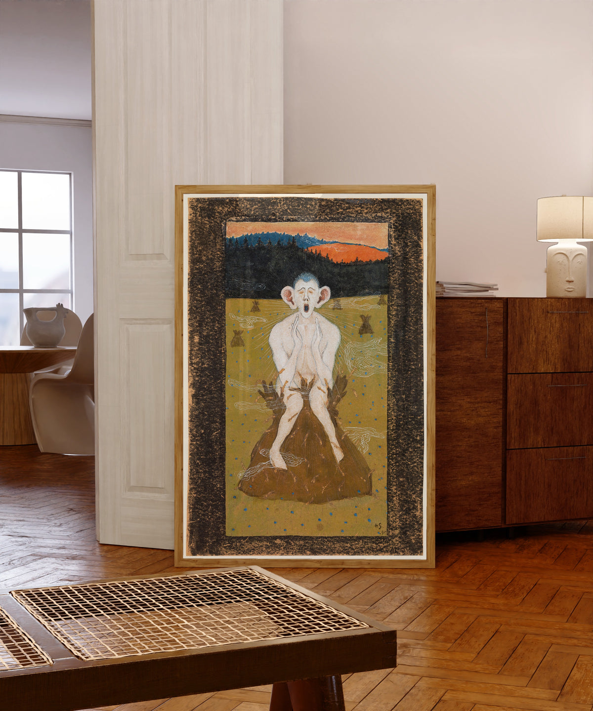Framed art print of Frost by Hugo Simberg, in a light wood frame leaning in a warm room with a parquet floor