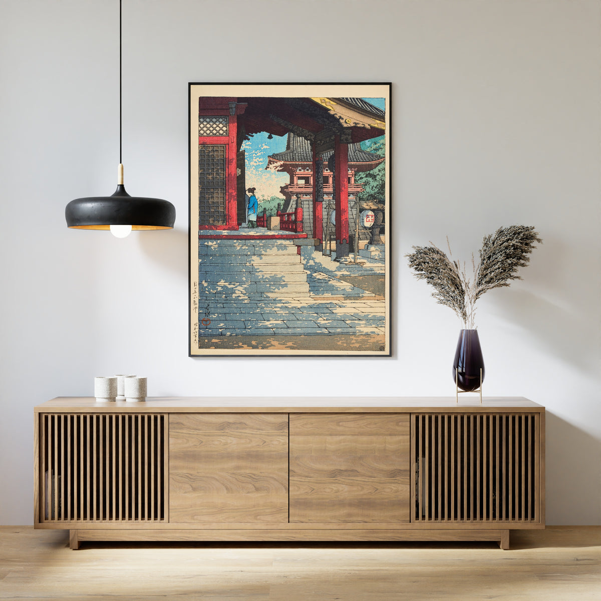 Framed art print of Fudo Hall in Meguro by Kawase Hasui, above a slatted wood sideboard