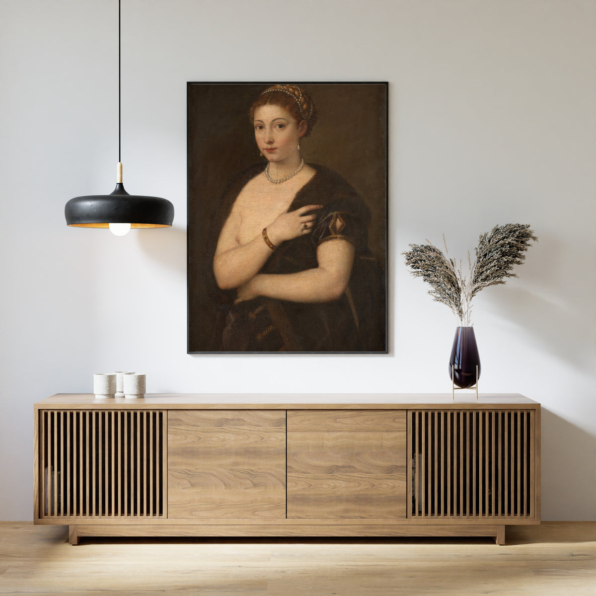 Framed art print of Girl in a Fur by Titian, above a slatted wood sideboard