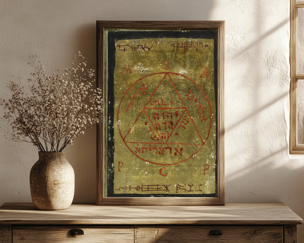 Framed art print of Gold Seal, from Cyprianus by Unknown artist, in a dark wood frame leaning on a rustic console beside dried flowers