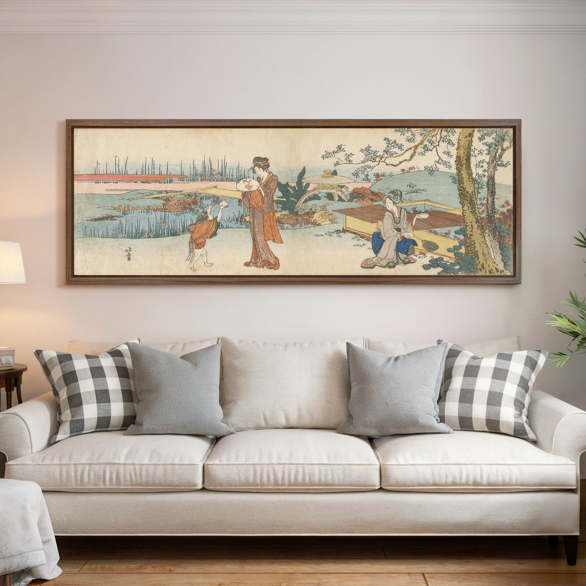 Framed art print of Goldfish Vendor by Katsushika Hokusai, above a cream sofa