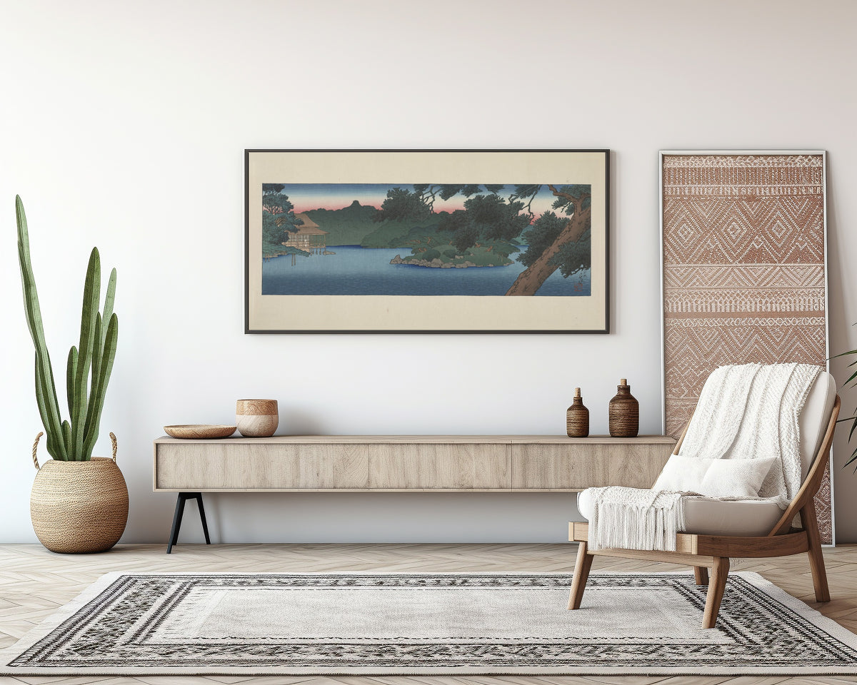 Framed art print of Guest House in the Pines, Mitsubishi Villa at Fukagawa by Kawase Hasui, above a sideboard in a living room