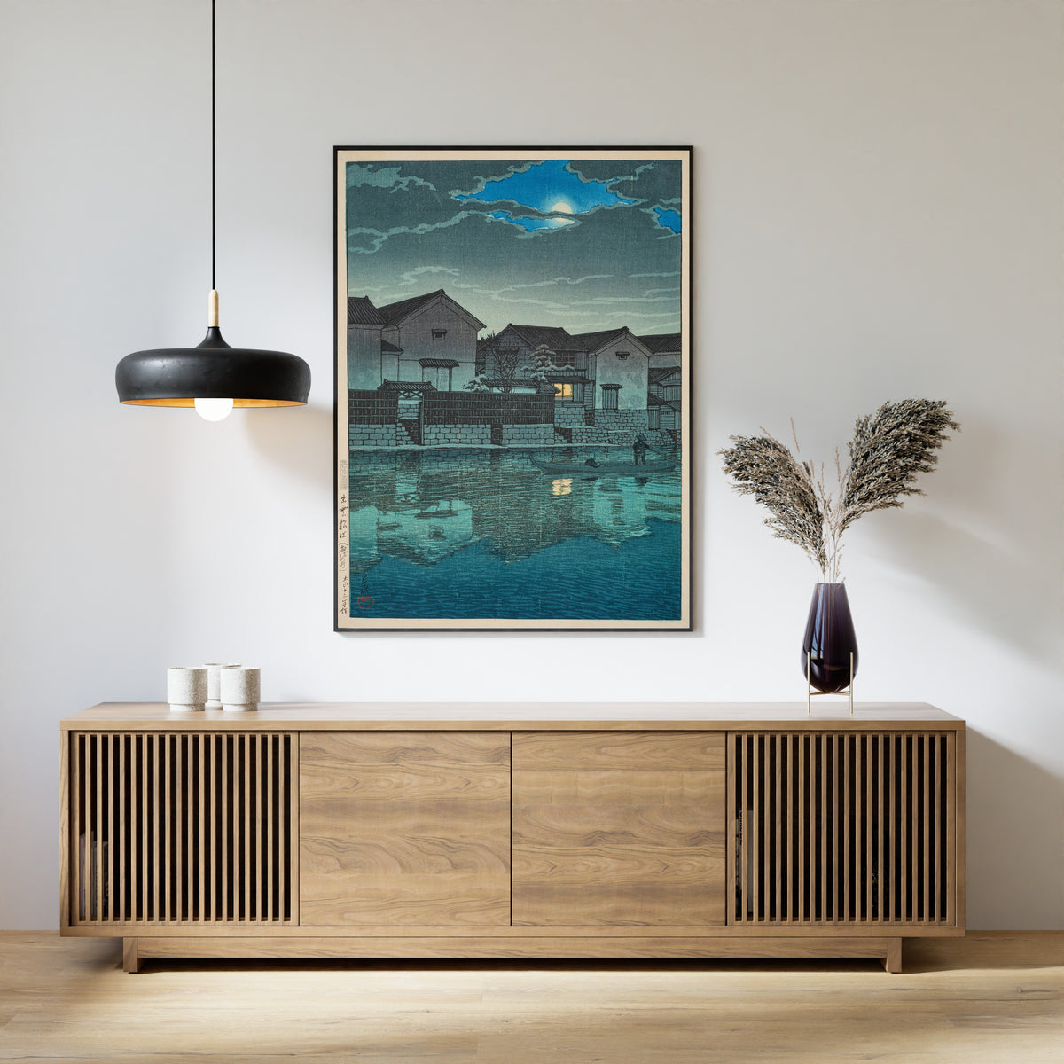 Framed art print of Hazy Moon at Matsue in Izumo by Kawase Hasui, above a slatted wood sideboard