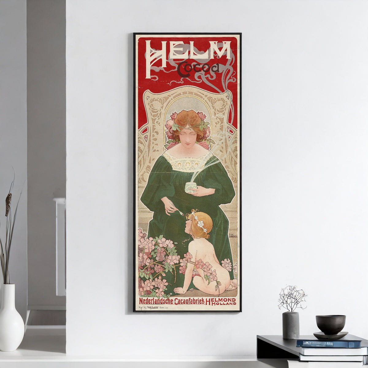 Framed art print of Helm Cocoa by Henri Privat-Livemont, on a white wall above books and a bowl