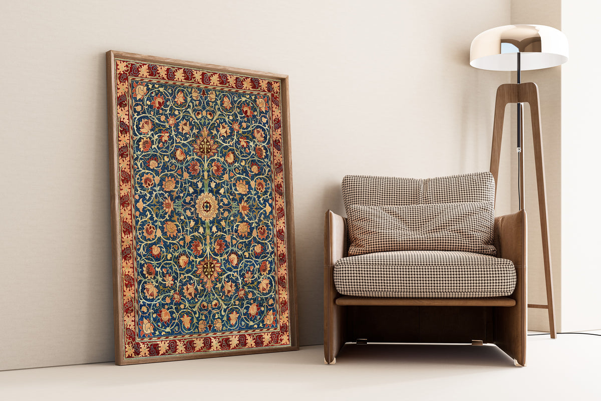 Framed art print of Holland Park Carpet by William Morris, leaning against a wall beside an armchair and a floor lamp