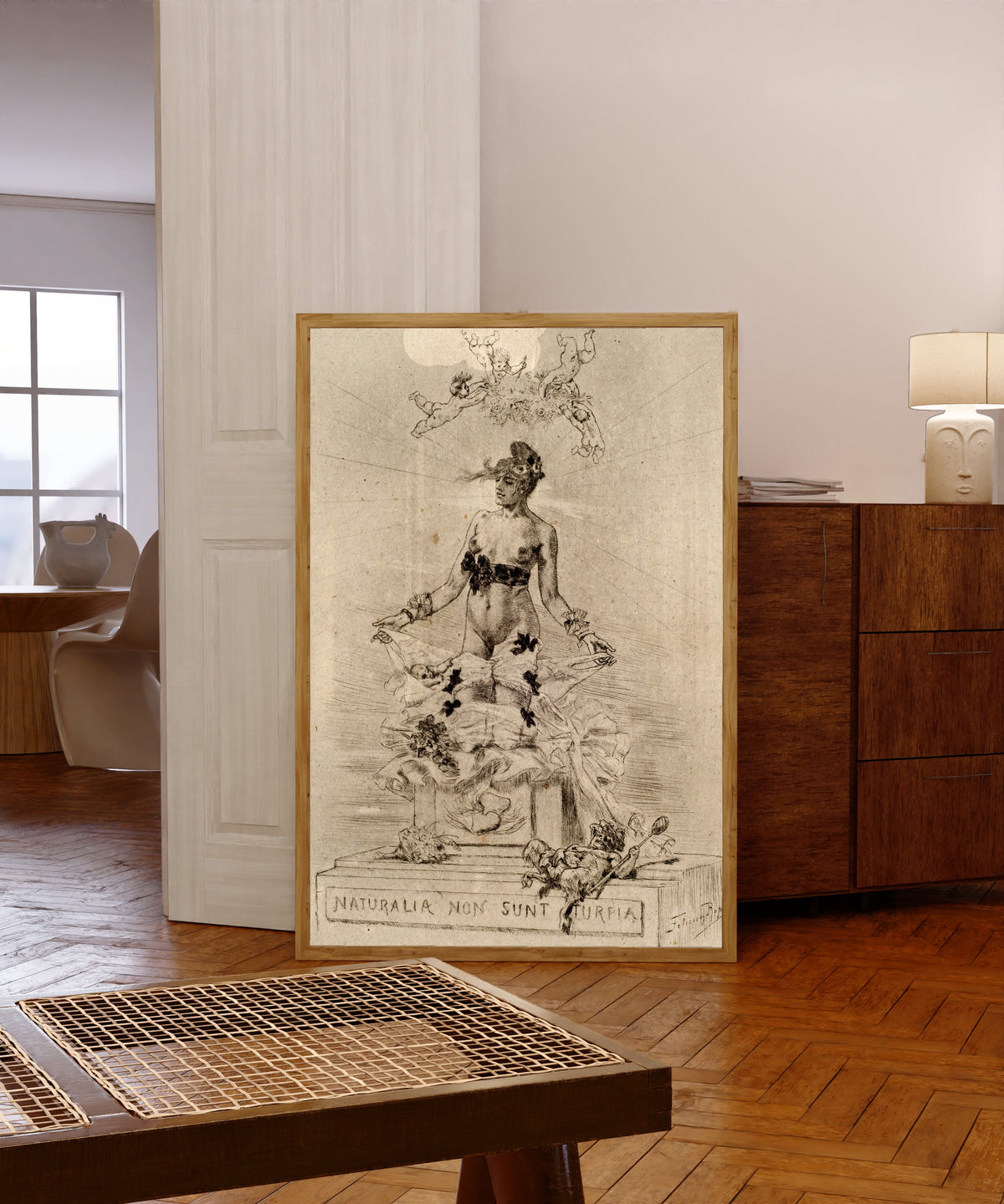 Framed art print of Holocauste, Naturalia Non Sunt Turpia by Félicien Rops, in a light wood frame leaning in a warm room with a parquet floor