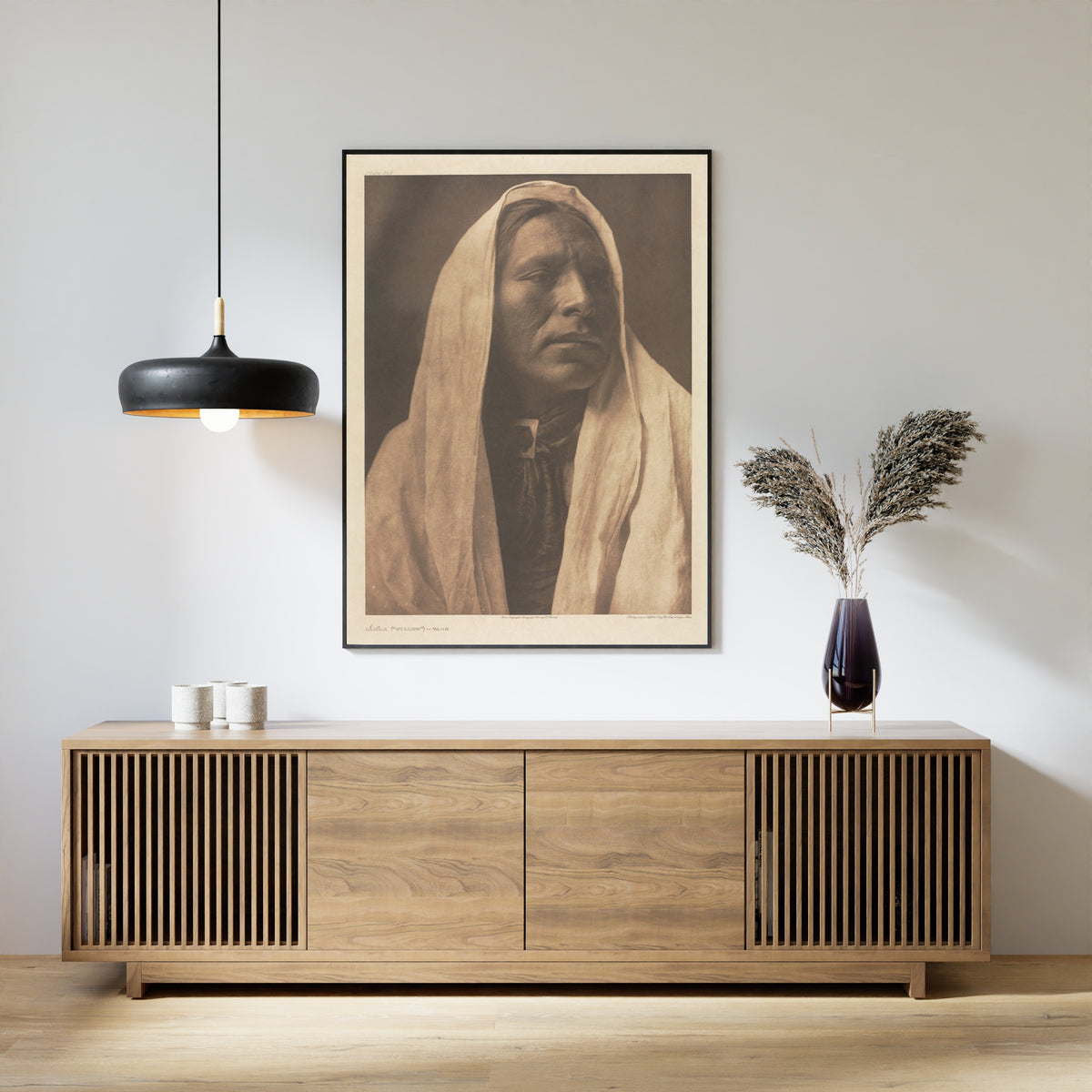 Framed art print of Iahla (Willow), Taos by Edward S. Curtis, above a slatted wood sideboard