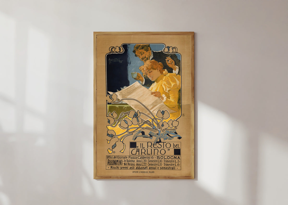 Framed art print of Il Resto del Carlino, Bologna by Adolfo Hohenstein, in a light wood frame on a sunlit white wall