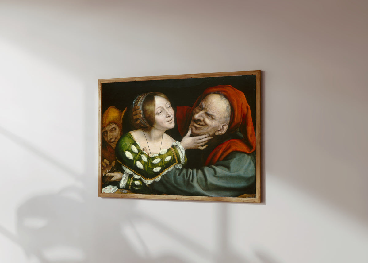 Framed art print of Ill-Matched Lovers by Quinten Massys, in a light wood frame on a sunlit white wall, seen at a slight angle