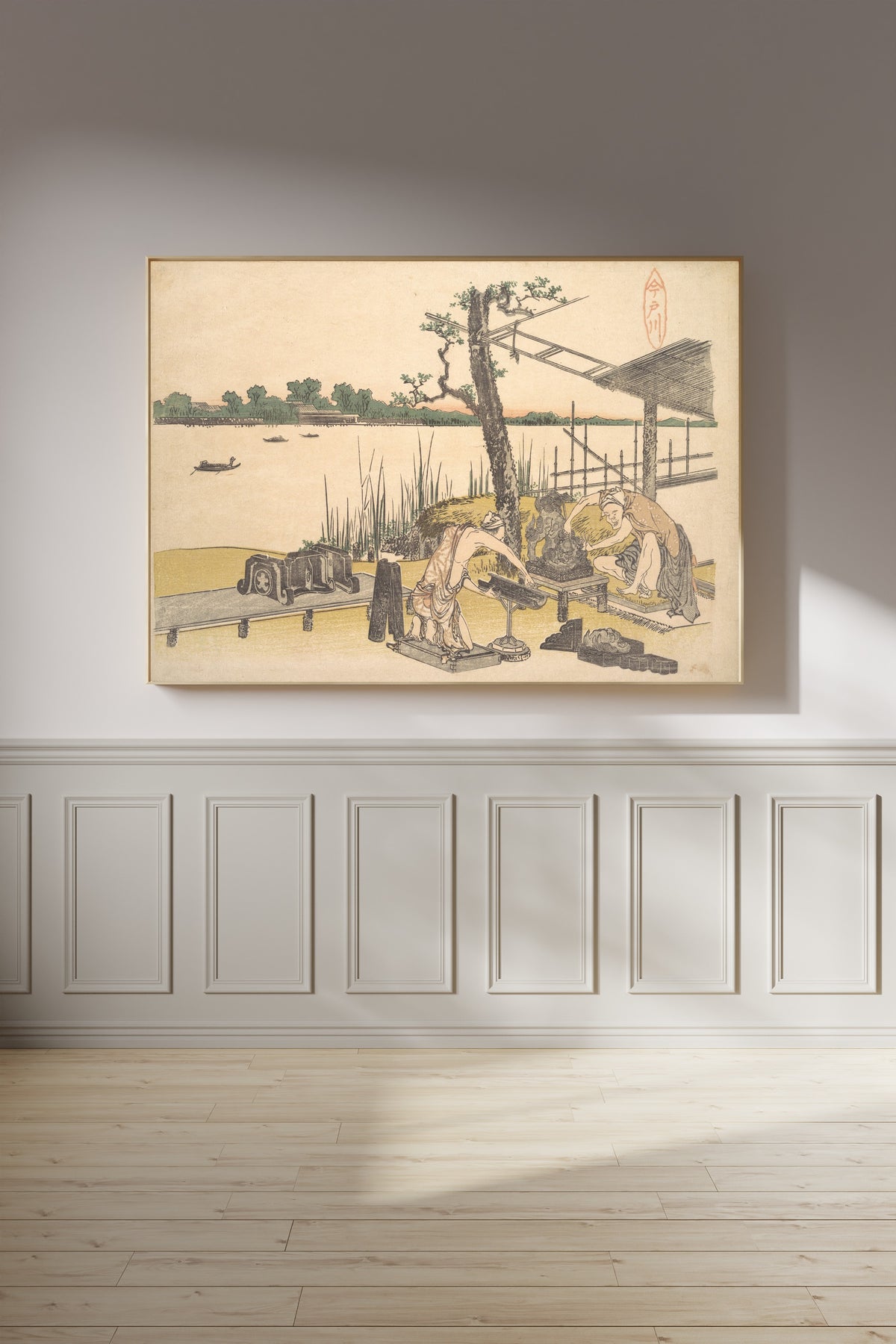 Framed art print of Imadogawa by Katsushika Hokusai, on a panelled wall in afternoon light