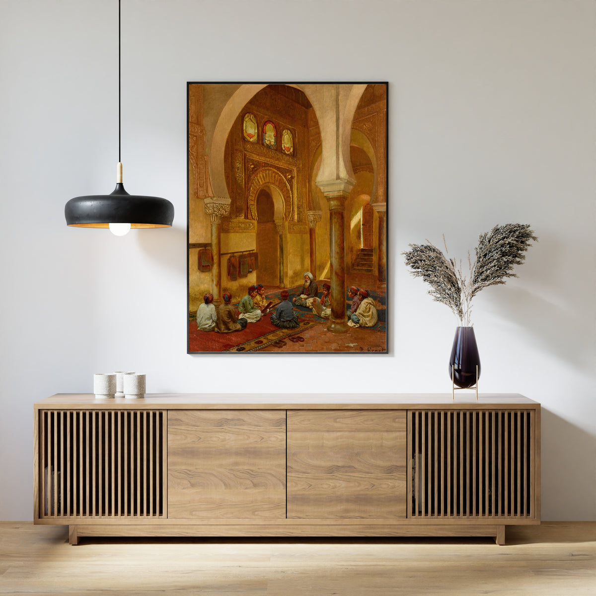 Framed art print of In the Madrasa by Rudolf Ernst, above a slatted wood sideboard