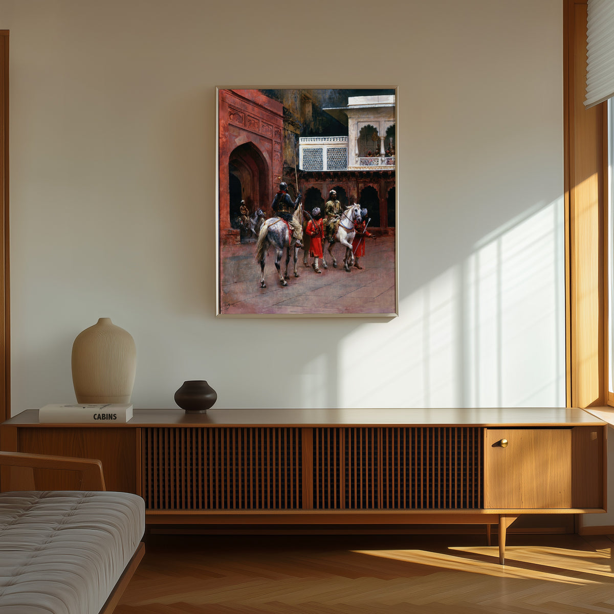 Framed art print of Indian Prince, Palace of Agra by Edwin Lord Weeks, in a thin light frame on a sunlit wall above a wooden sideboard