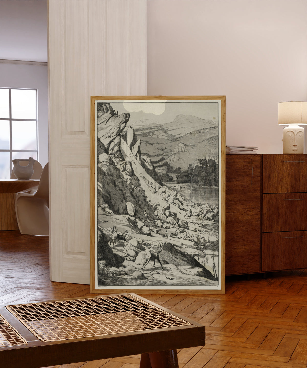 Framed art print of Intermezzi: Landslide by Max Klinger, in a light wood frame leaning in a warm room with a parquet floor
