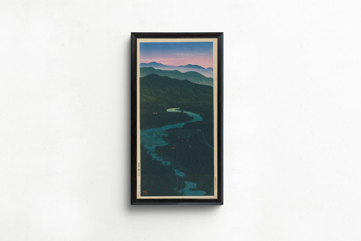Framed art print of Ioridani Pass, Etchu by Kawase Hasui, in a slim black frame on a plain white wall