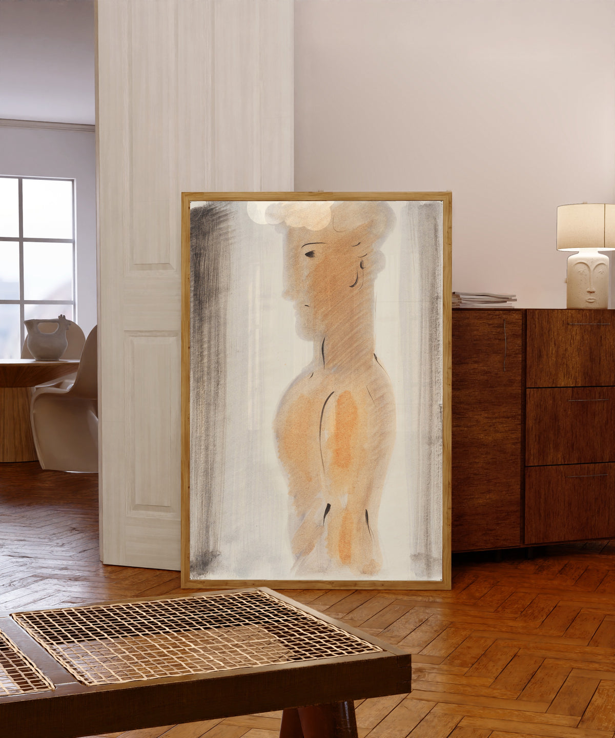 Framed art print of Jünglingsfigur im Profil by Oskar Schlemmer, in a light wood frame leaning in a warm room with a parquet floor
