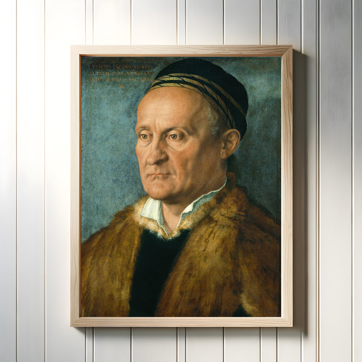 Framed art print of Jakob Muffel by Albrecht Dürer, in a light wood frame on a white panelled wall