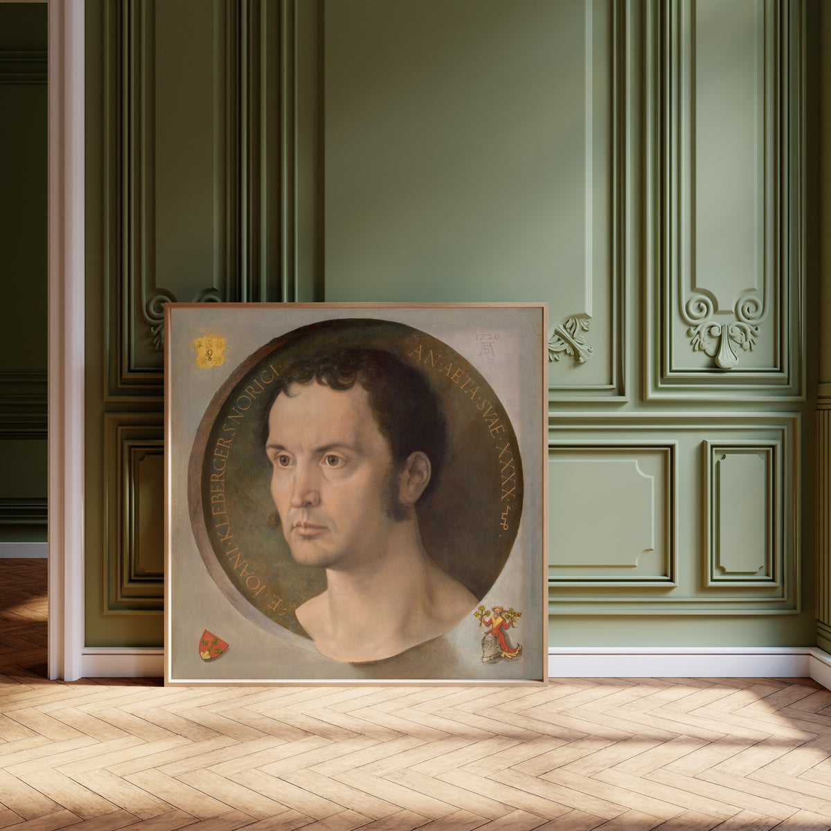 Framed art print of Johannes Kleberger by Albrecht Dürer, leaning against olive-green panelling on a herringbone floor