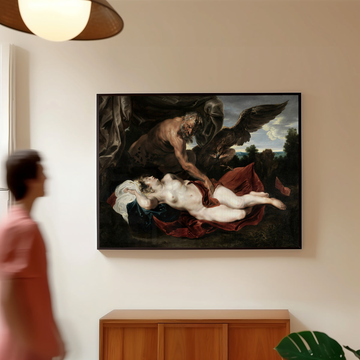 Framed art print of Jupiter and Antiope by Anthony van Dyck, in a slim black frame on a warm wall in a sunlit room