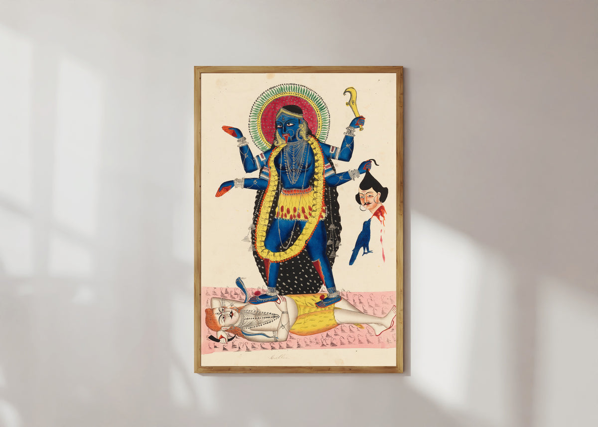 Framed art print of Kali Trampling Upon Shiva by Kalighat painter, in a light wood frame on a sunlit white wall