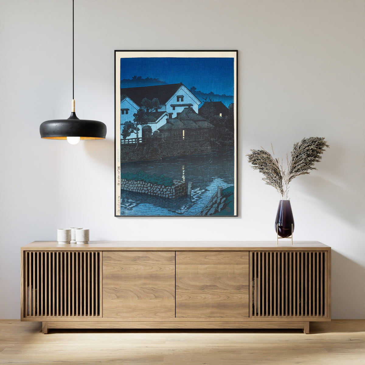 Framed art print of Kasuga-cho, Kumamoto by Kawase Hasui, above a slatted wood sideboard