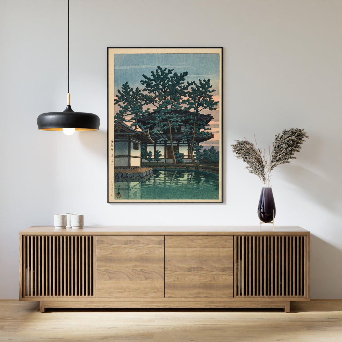 Framed art print of Kiko Temple, Nara Prefecture by Kawase Hasui, above a slatted wood sideboard