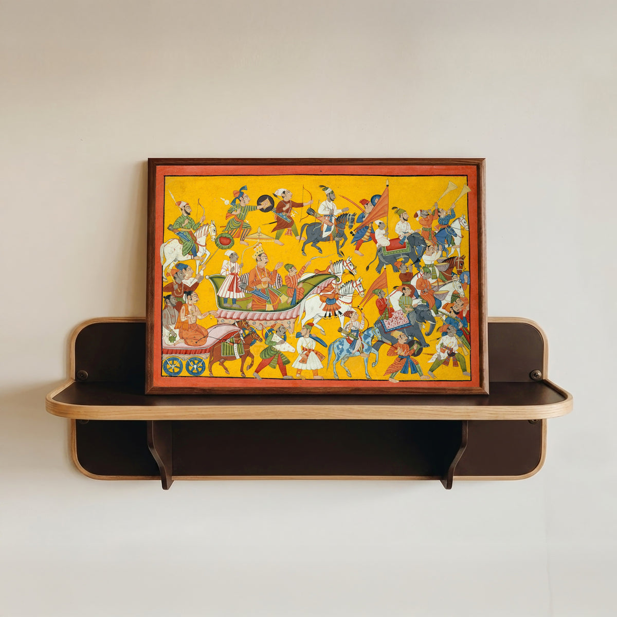 Framed art print of King Dasaratha and His Retinue Proceed to Rama's Wedding: Folio from the… by Mankot school, in a dark wood frame resting on a wall shelf