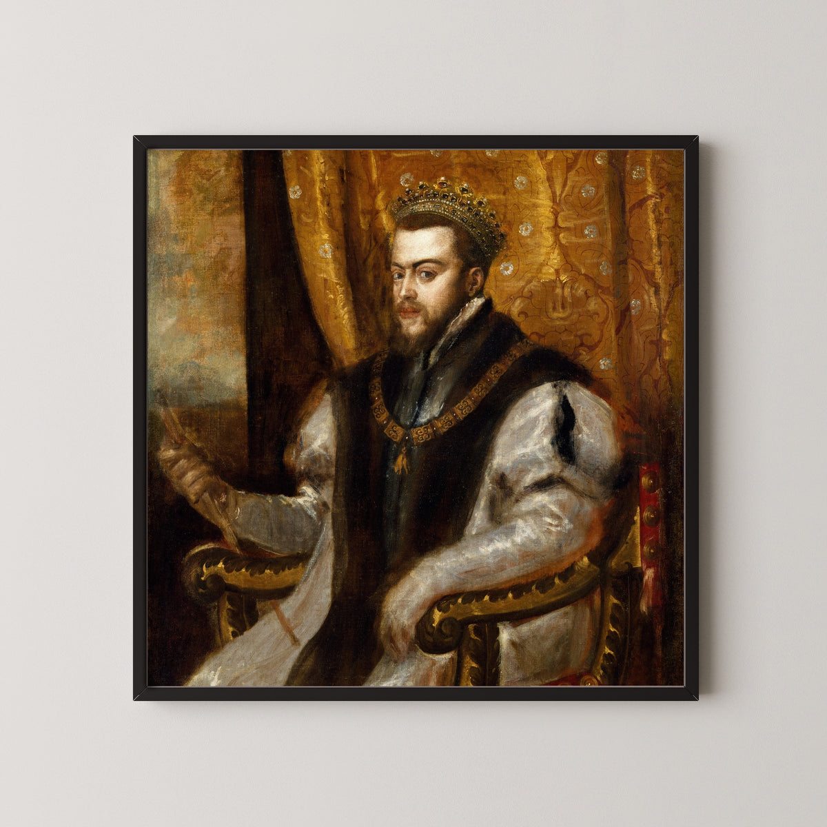 Framed art print of King Philip II of Spain by Titian, in a black frame on a pale wall