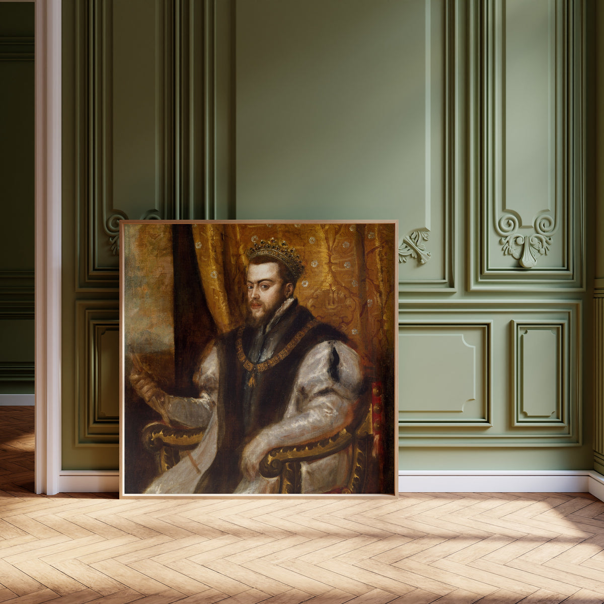 Framed art print of King Philip II of Spain by Titian, leaning against olive-green panelling on a herringbone floor