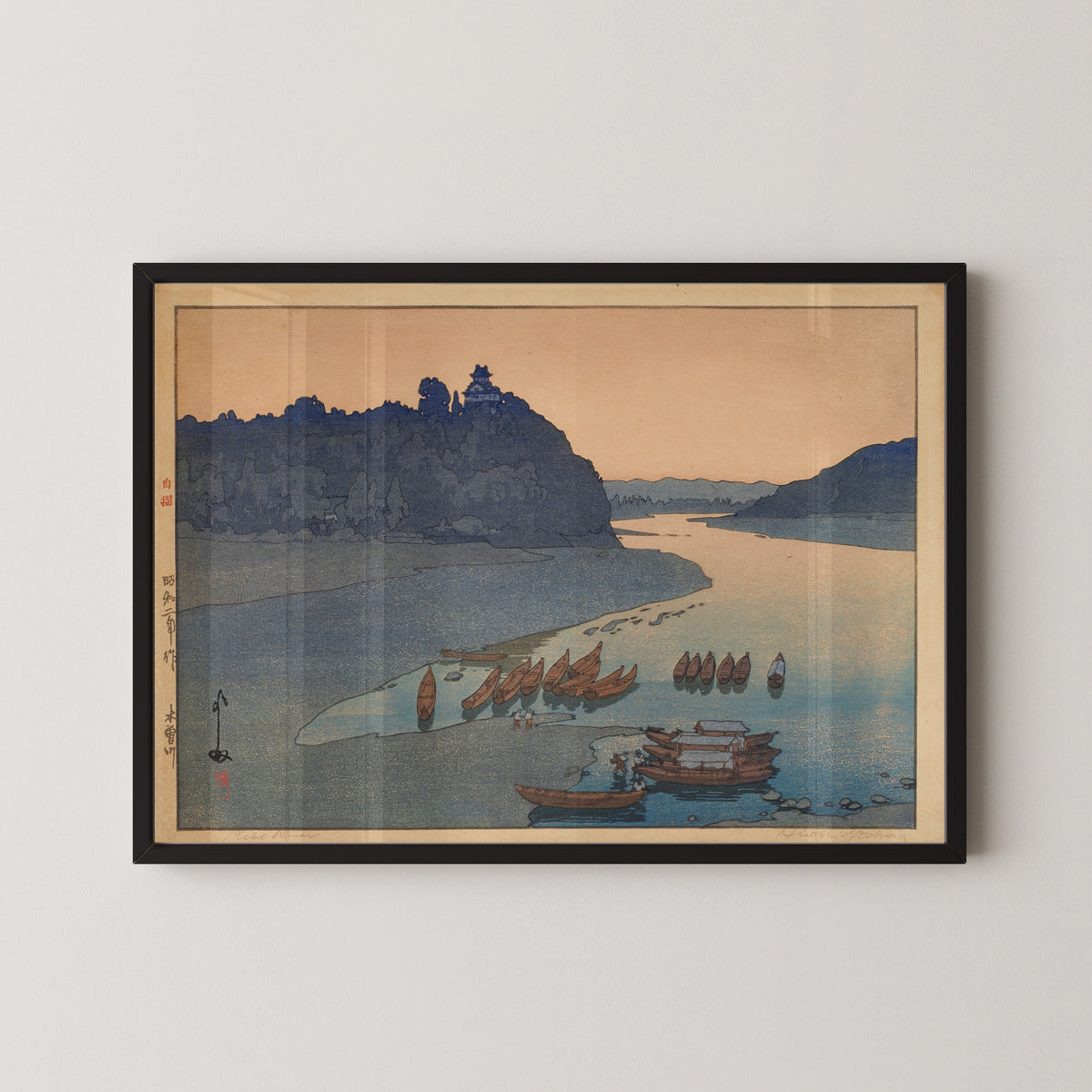 Framed art print of Kiso River by Hiroshi Yoshida, in a black frame on a pale wall