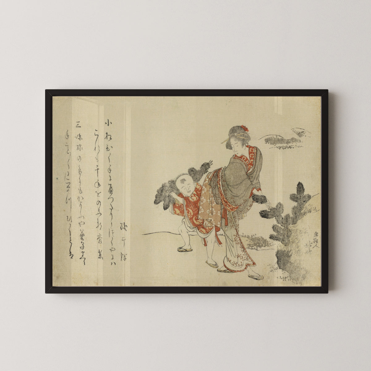 Framed art print of Komatsubiki by Katsushika Hokusai, in a black frame on a pale wall