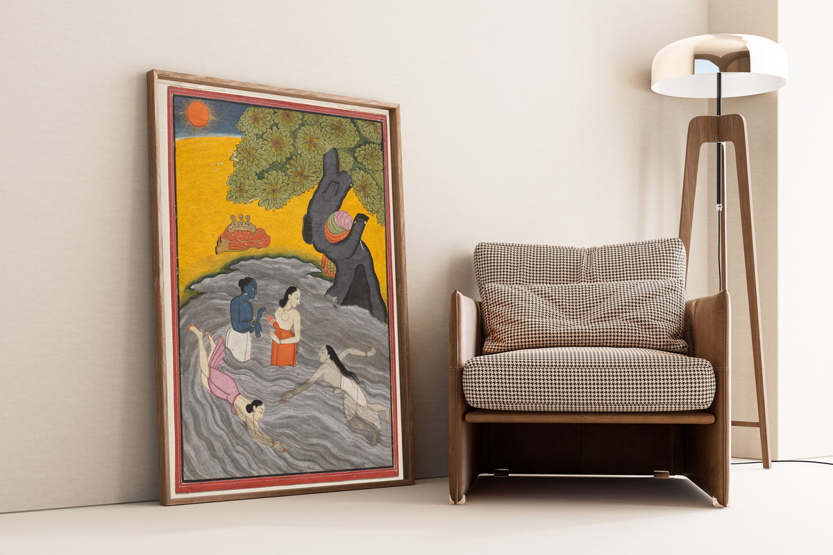 Framed art print of Krishna Playing with the Gopis in the Yamuna by Pahari school, leaning against a wall beside an armchair and a floor lamp
