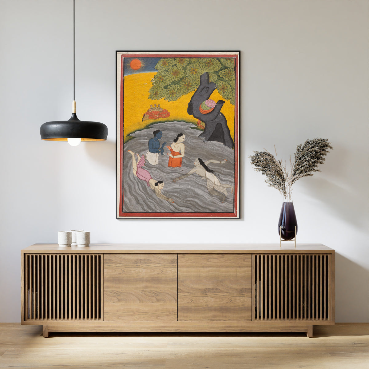 Framed art print of Krishna Playing with the Gopis in the Yamuna by Pahari school, above a slatted wood sideboard