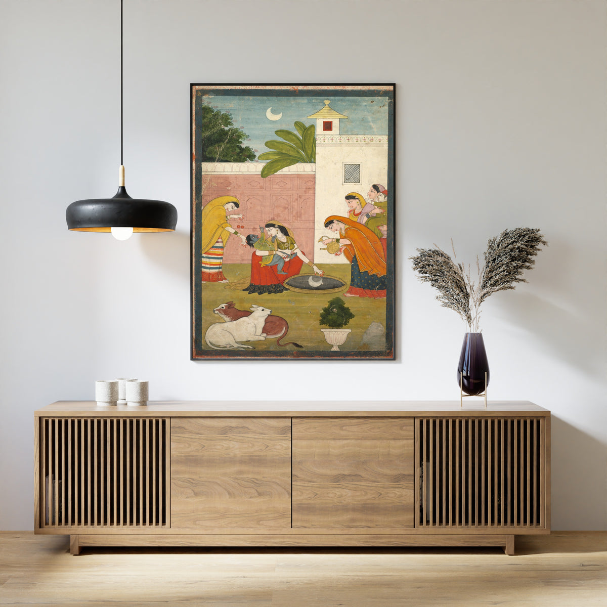 Framed art print of Krishna Reaching for the Moon by Pahari school, above a slatted wood sideboard