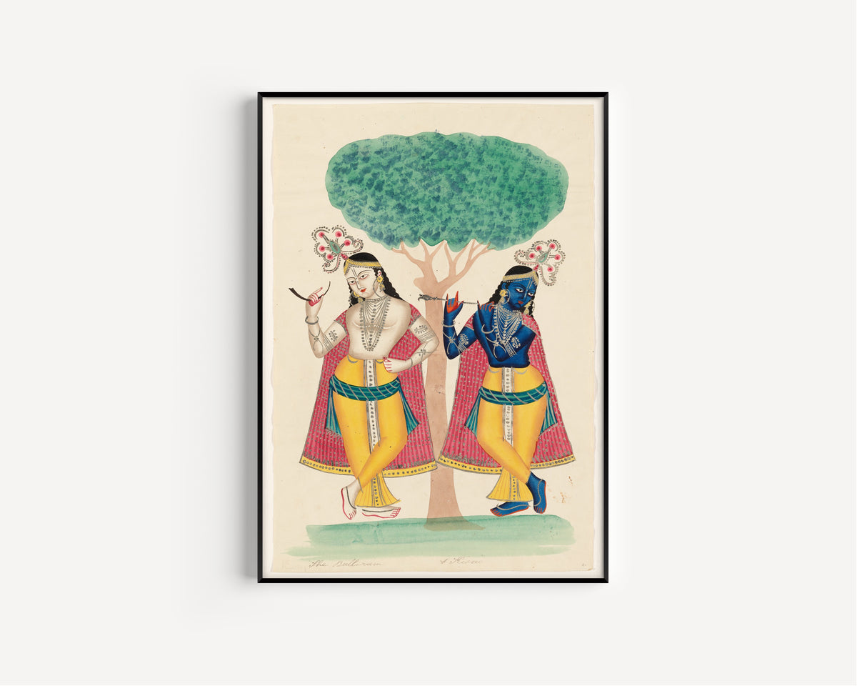Framed art print of Krishna and Balarama underneath a Tree by Kalighat painter, in a slim black frame on a plain white wall