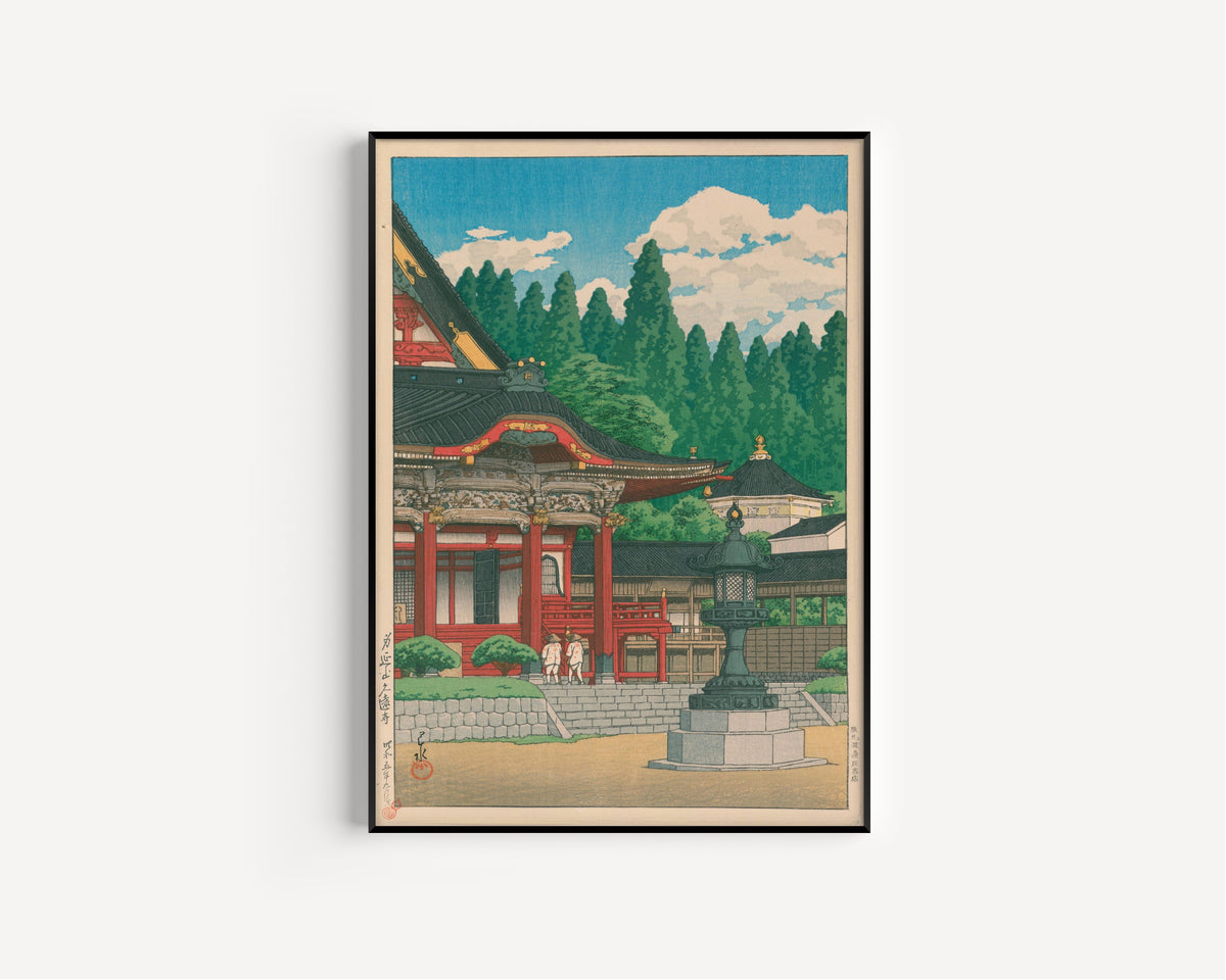 Framed art print of Kuonji Temple at Mount Minobu by Kawase Hasui, in a slim black frame on a plain white wall