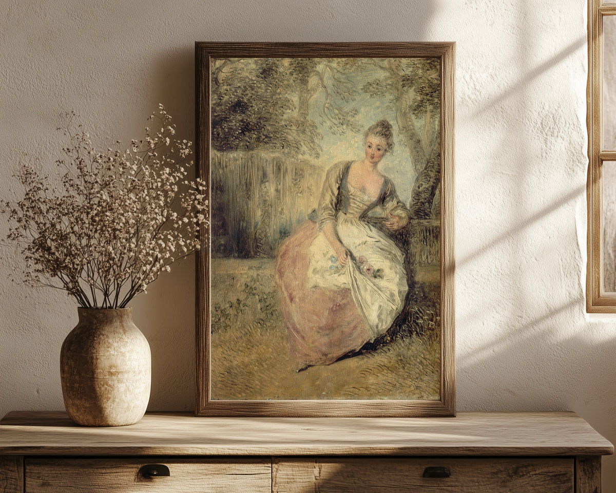 Framed art print of L'Amante inquiète by Jean-Antoine Watteau, in a dark wood frame leaning on a rustic console beside dried flowers