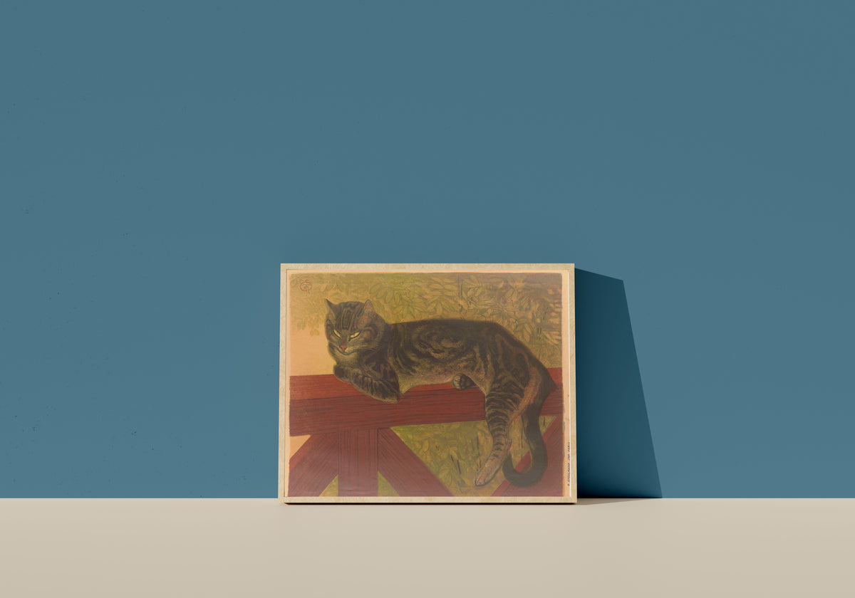 Framed art print of L’Été, chat sur une balustrade by Théophile Steinlen, in a light wood frame leaning on a blue wall