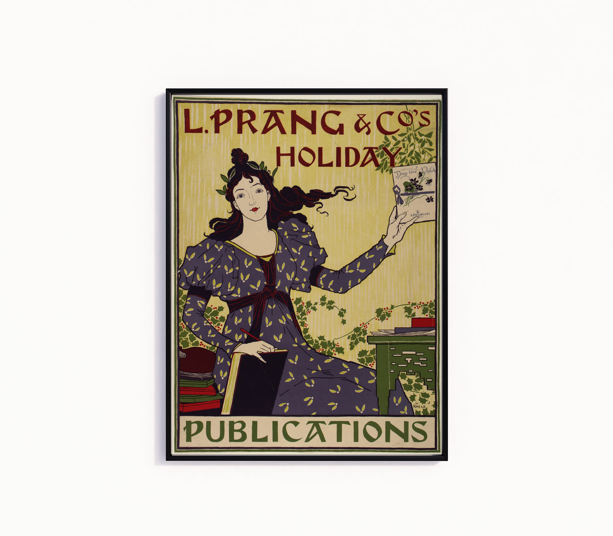 Framed art print of L. Prang & Co.'s Holiday Publications by Louis Rhead, in a slim black frame on a plain white wall