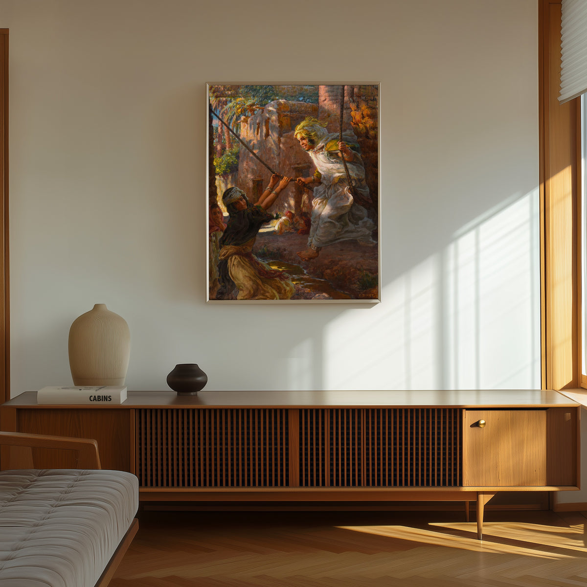 Framed art print of La Balançoire by Étienne Dinet, in a thin light frame on a sunlit wall above a wooden sideboard