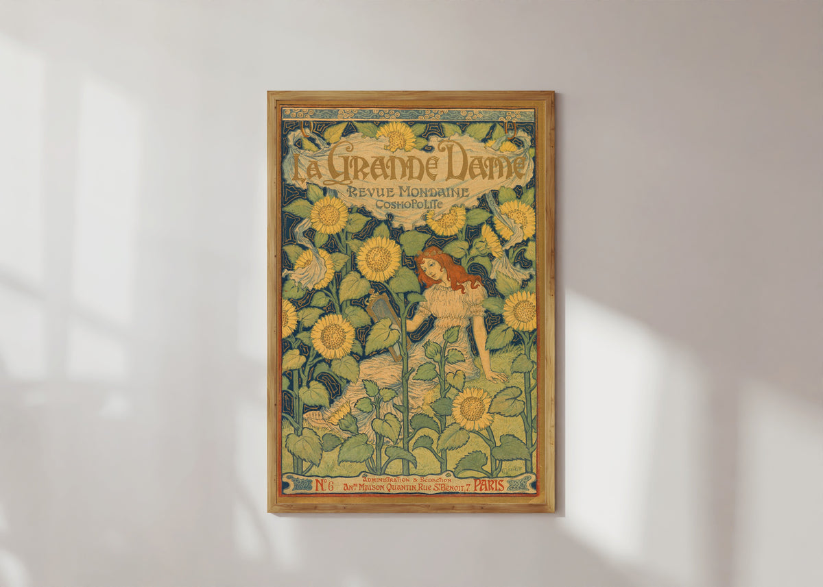 Framed art print of La Grande Dame by Eugène Grasset, in a light wood frame on a sunlit white wall