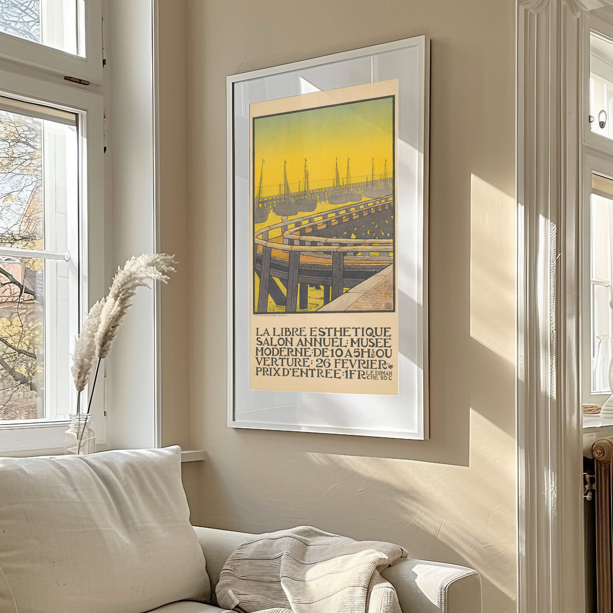 Framed art print of La Libre Esthétique, Salon Annuel (1903) by Gisbert Combaz, in a sunlit living room above a sofa