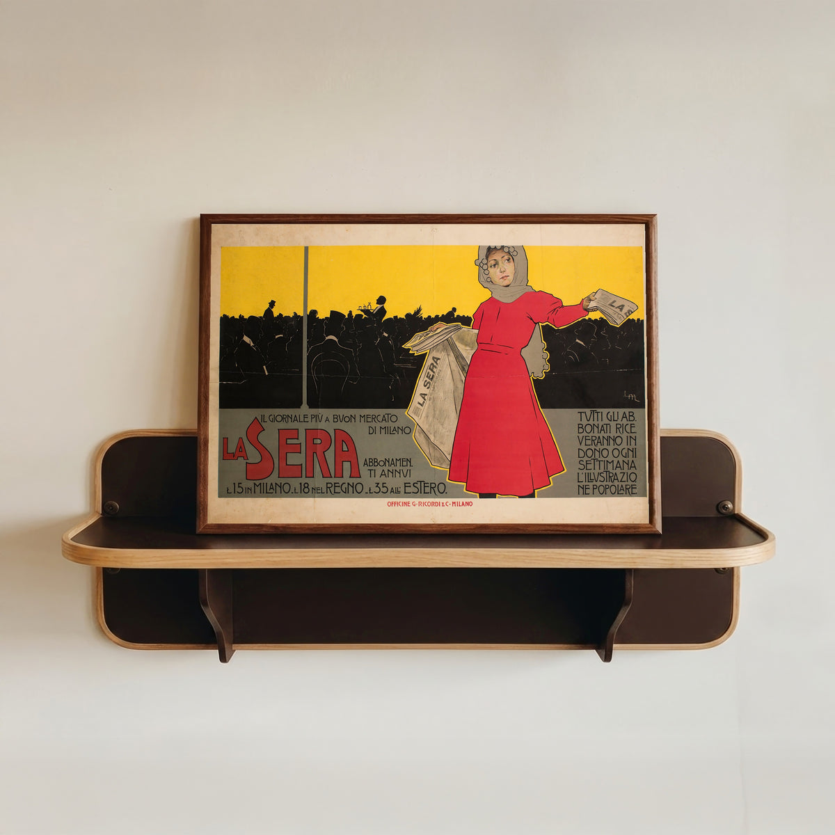 Framed art print of La Sera by Leopoldo Metlicovitz, in a dark wood frame resting on a wall shelf