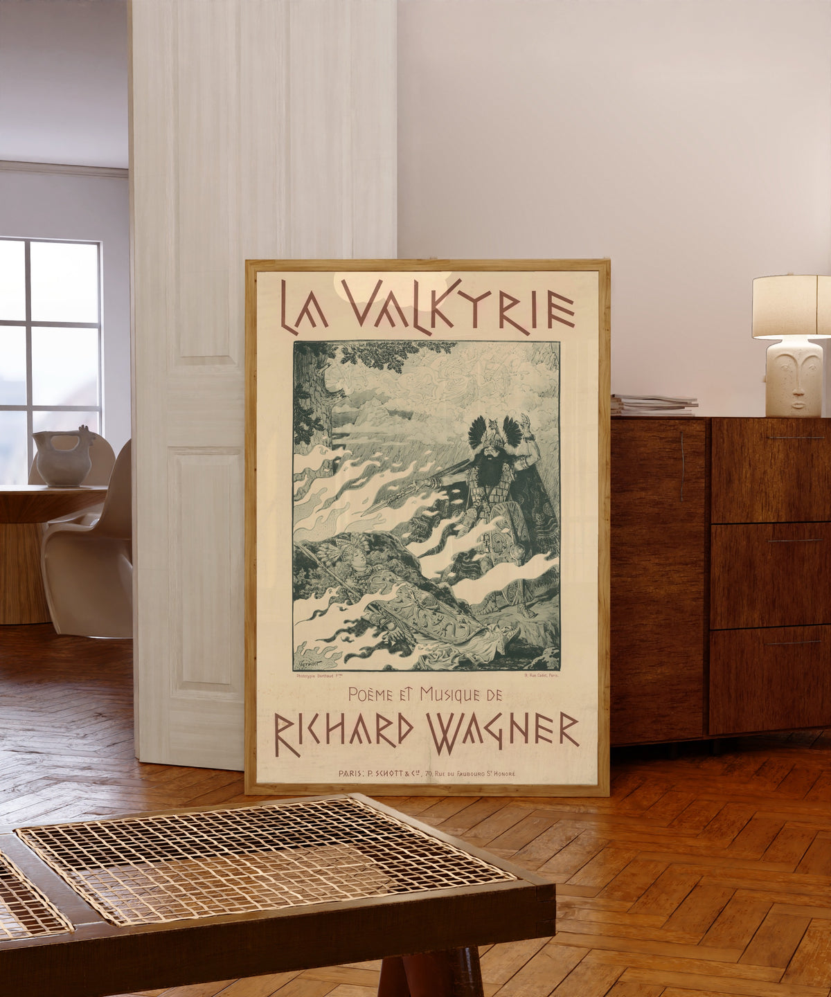 Framed art print of La Valkyrie. Poème et Musique de Richard Wagner by Eugène Grasset, in a light wood frame leaning in a warm room with a parquet floor